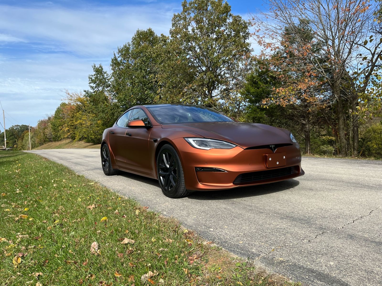 A copper color-change wrap on a sedan