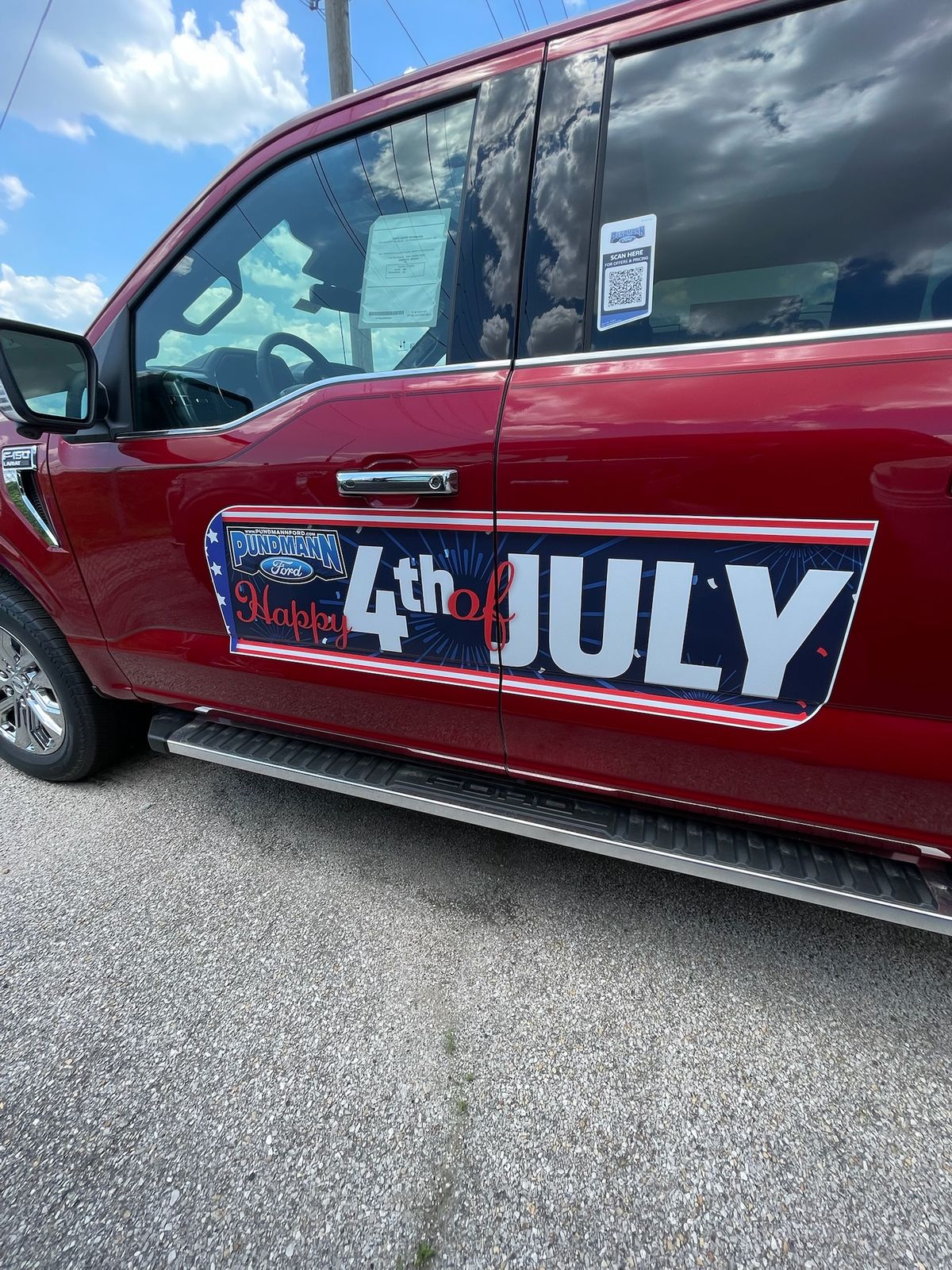 A body side reading Happy 4th of July on a pickup