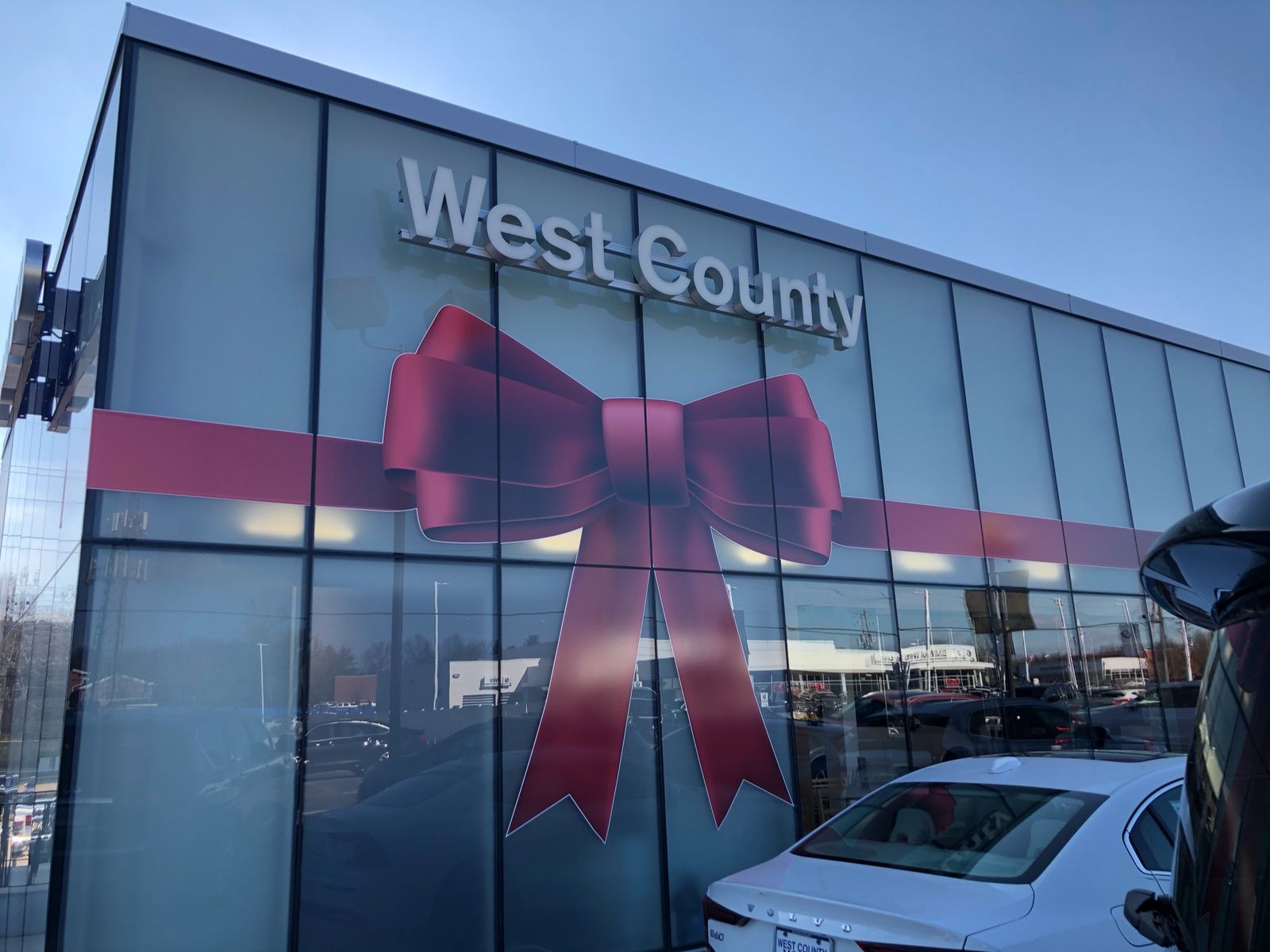 A ribbon and bow across showroom glass