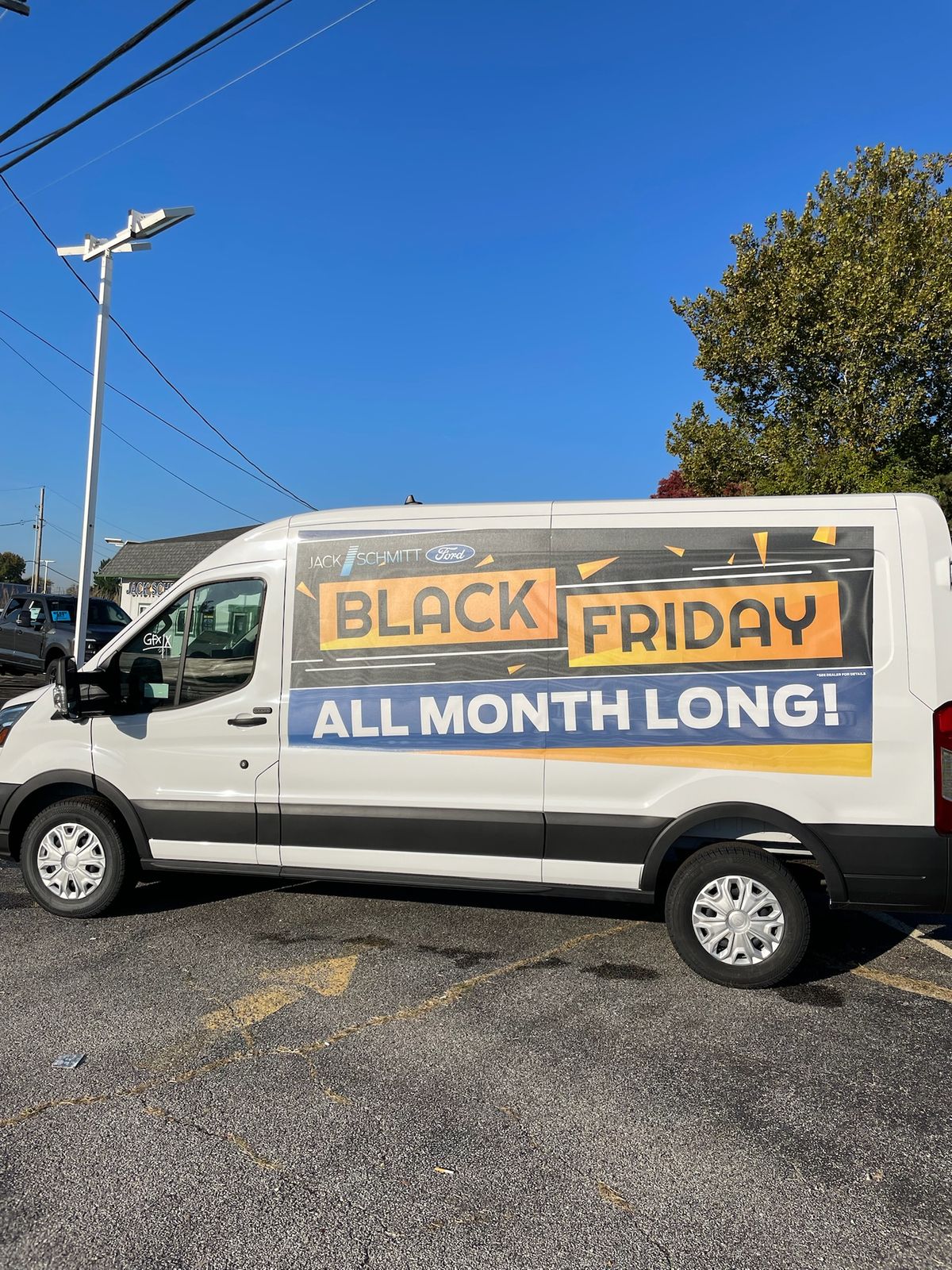 A cargo banner on a van reading Black Friday All Month Long!