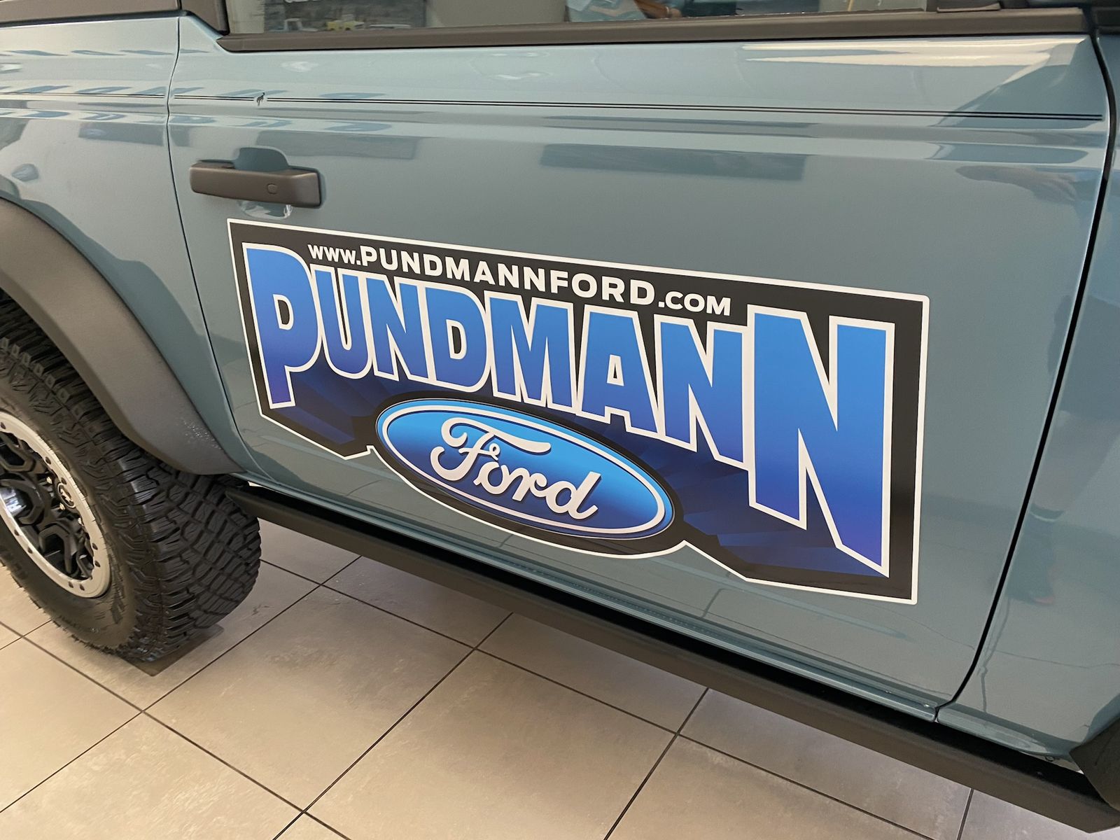 A door graphic with the store's name and website