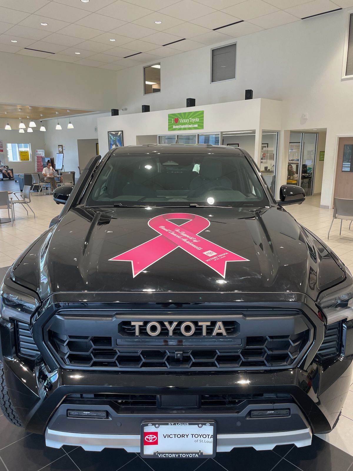 A pink ribbon hood graphic on a Tacoma